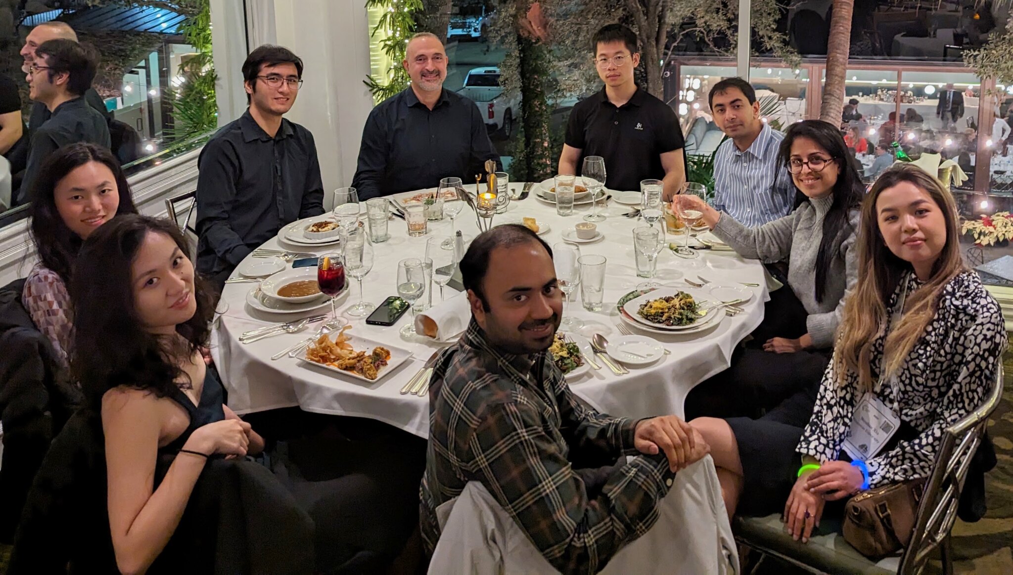 Research group gathered around a dinner table